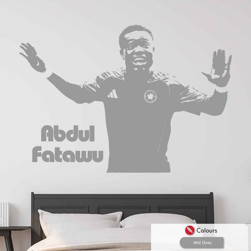 Wall decal of a leicester city footballer Abdul Fatawu with arms outstretched on a bedroom wall.
