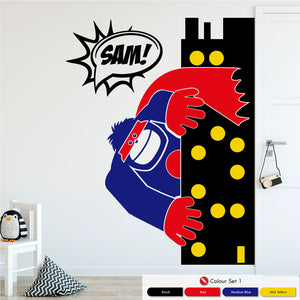 Gorilla leaning out from a skyline tower in black, red, medium blue and mid yellow